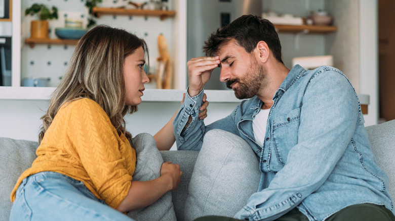 A couple talking on a couch