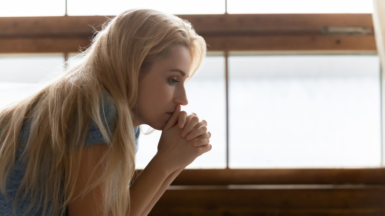 Pensive woman sitting down