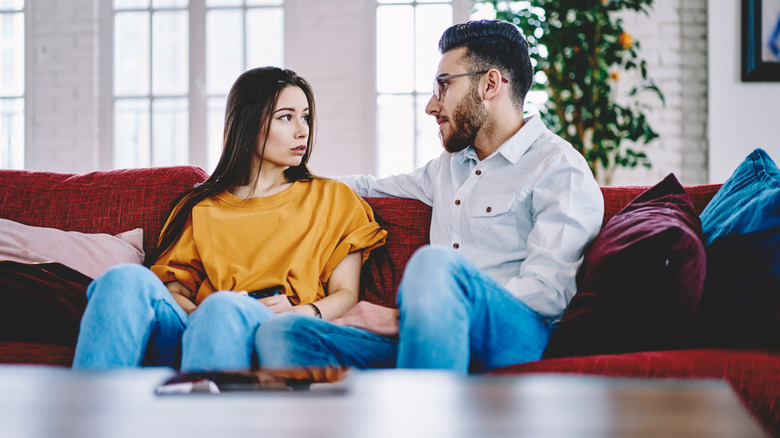 Couple talking on sofa