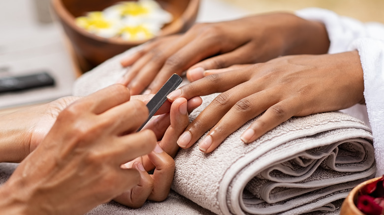 getting nails filed at salon