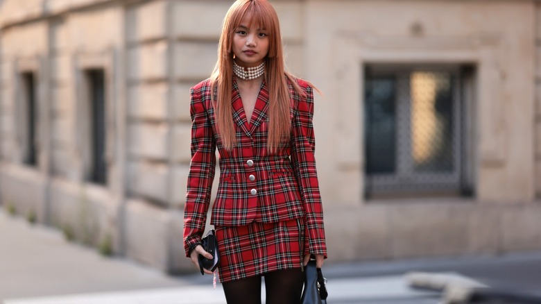 Mia Fa Wells wearing red plaid skirt and blazer