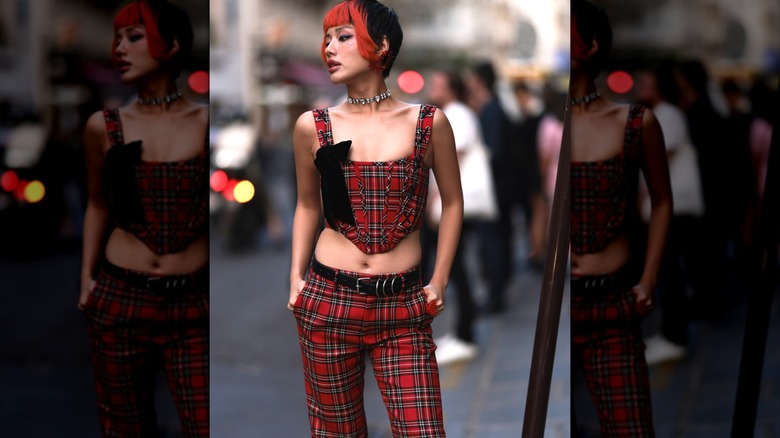 Woman wearing red plaid corset and trousers