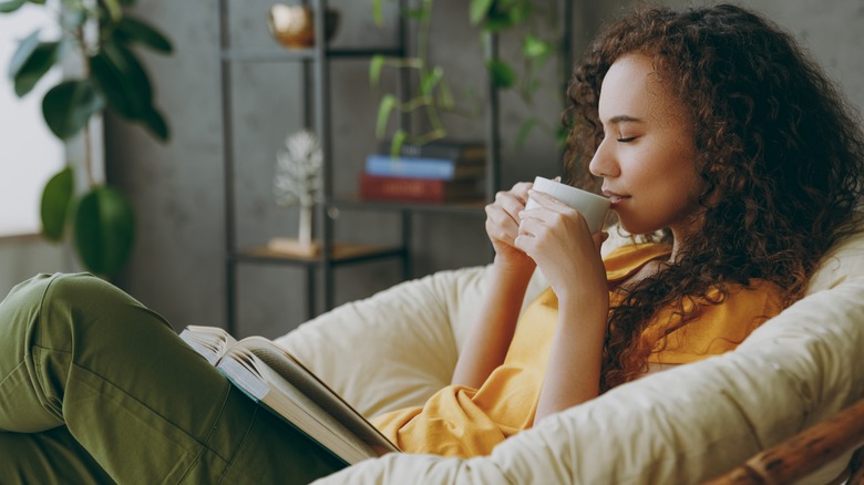Woman reads book with coffee 
