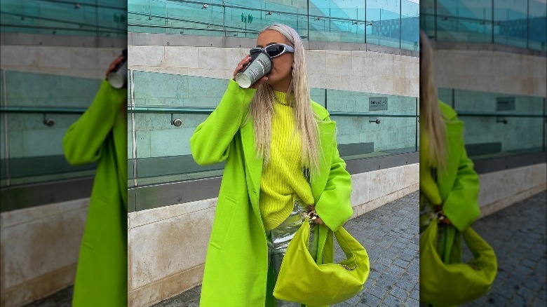 Woman poses with chartreuse handbag