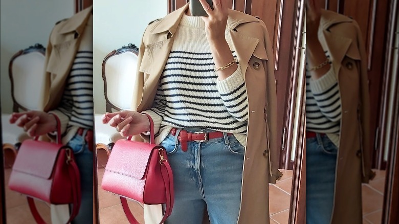 Woman poses with red handbag