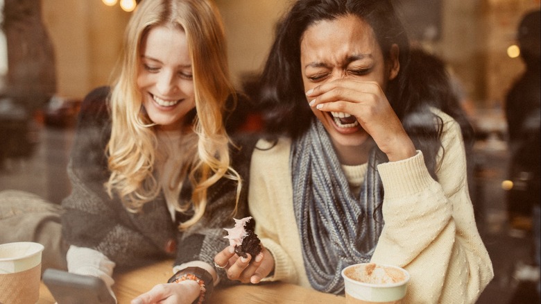 Two women laughing together