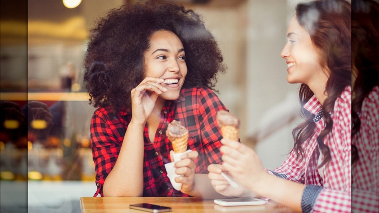 Two women speaking at table