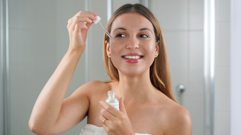 woman applying skincare product