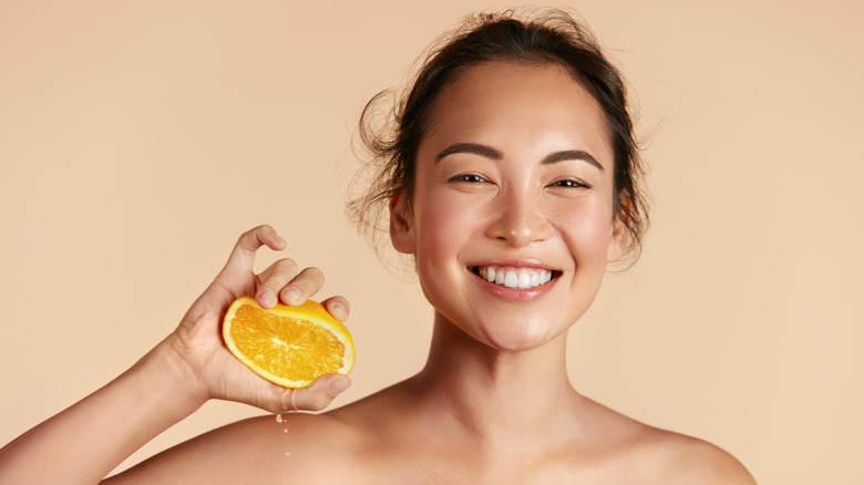 woman squeezing orange