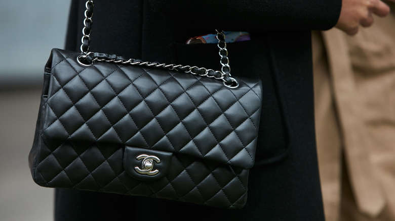 A woman wearing a Chanel bag