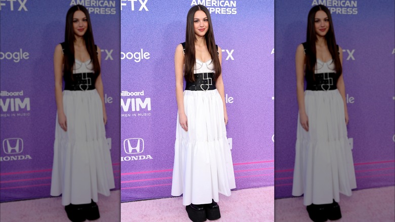 Olivia Rodrigo white dress black belts