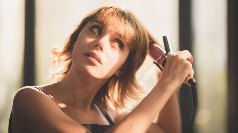 Woman brushing shorter hair