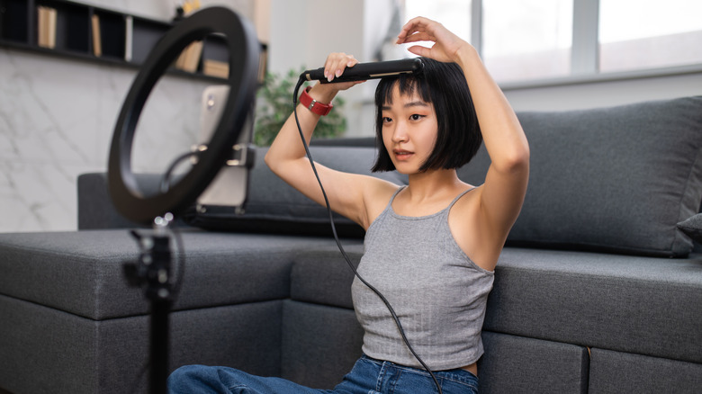 Woman curling shorter hair