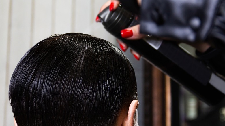 Spray being applied to hair