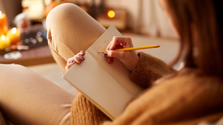 woman writing in notebook