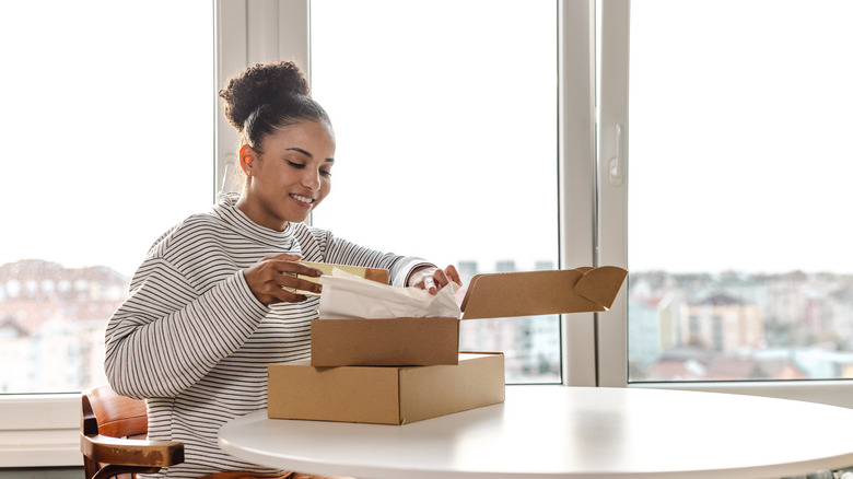 woman opening package