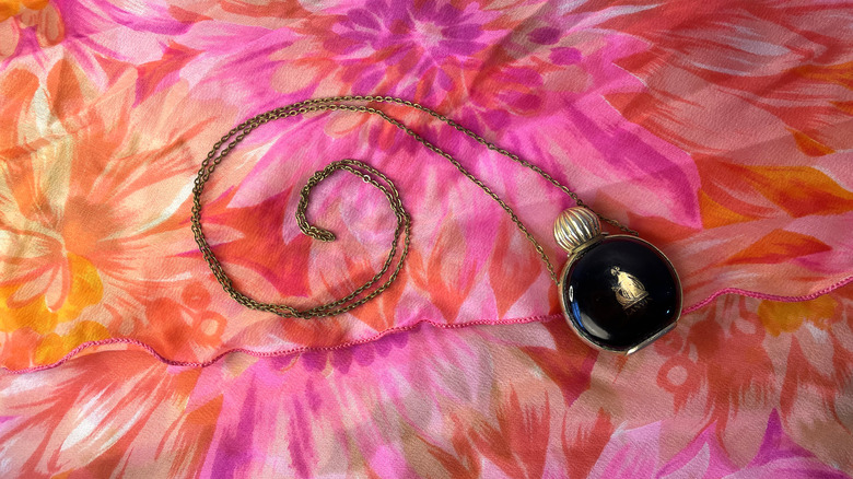 Perfume necklace with colorful background