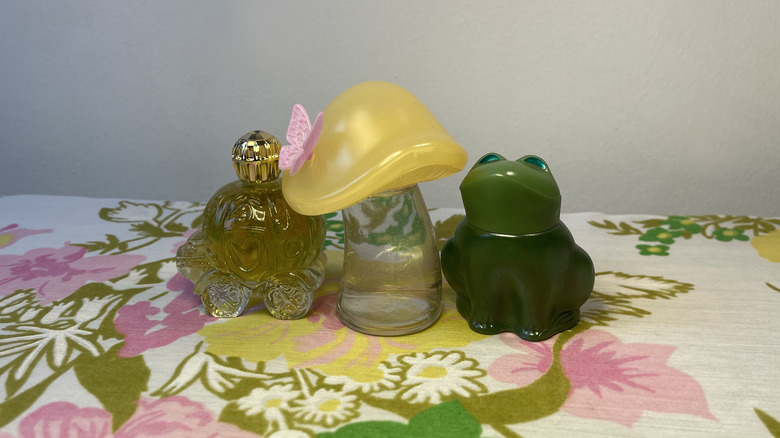 Avon perfume bottles on tablecloth