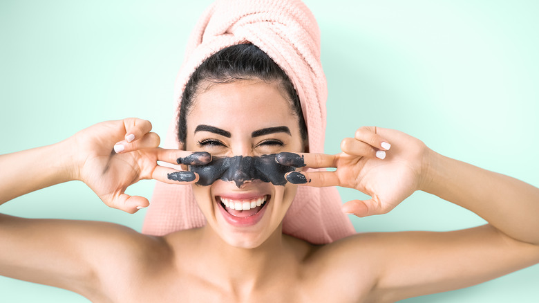 Woman applying a face mask