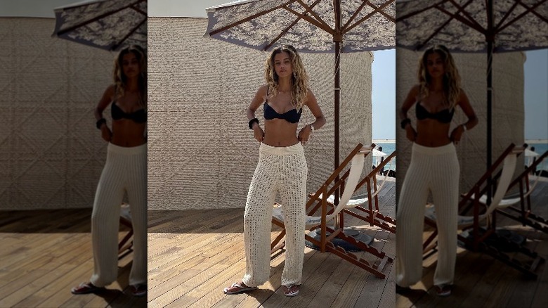 woman with black bikini top and crochet pants