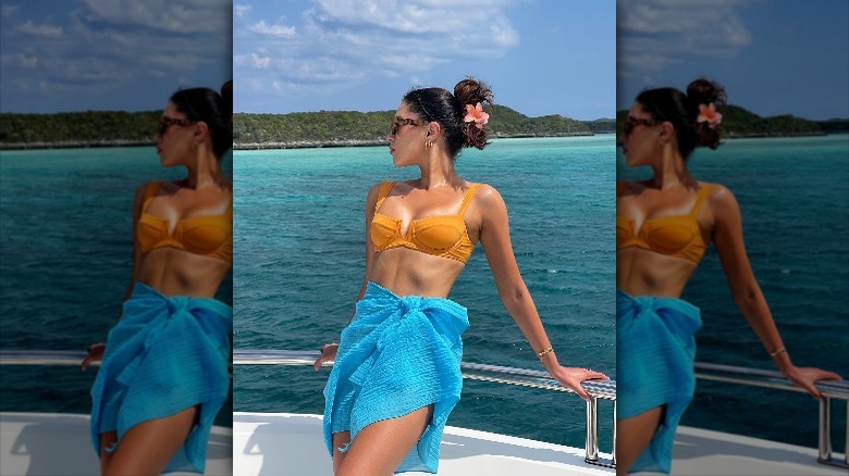 woman on boat with swimsuit and sarong