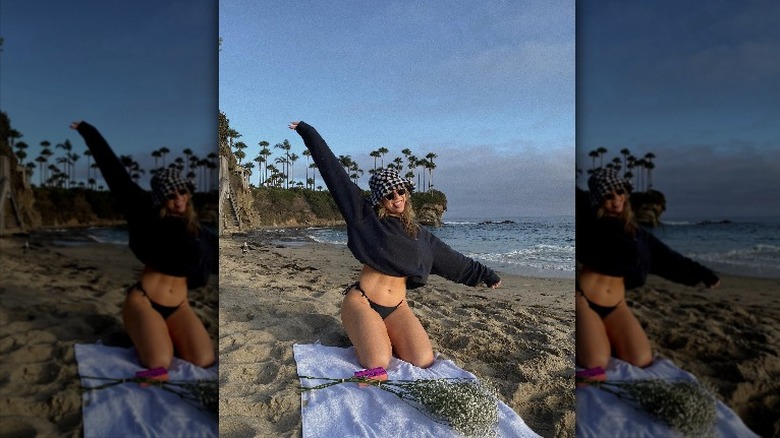 woman on beach wearing bikini and sweater