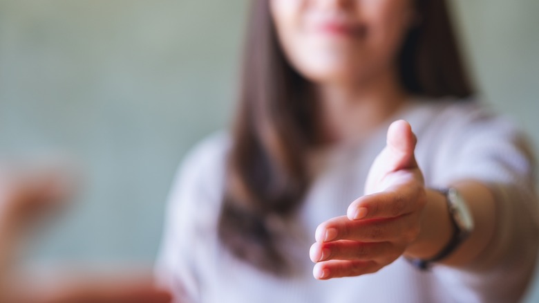 Close up of woman extending a hand to shake