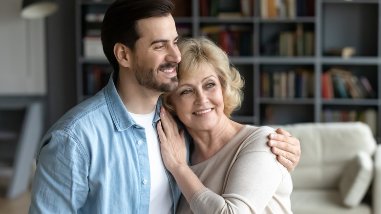 Older woman and son embracing