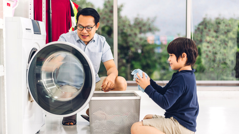 Dad doing laundry with son