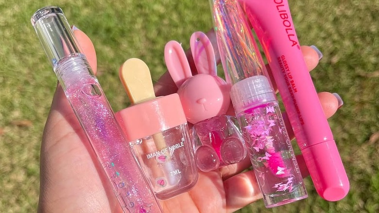 Person holding cute flavored lip glosses