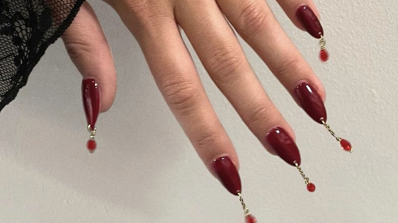 nails with dangling piercings