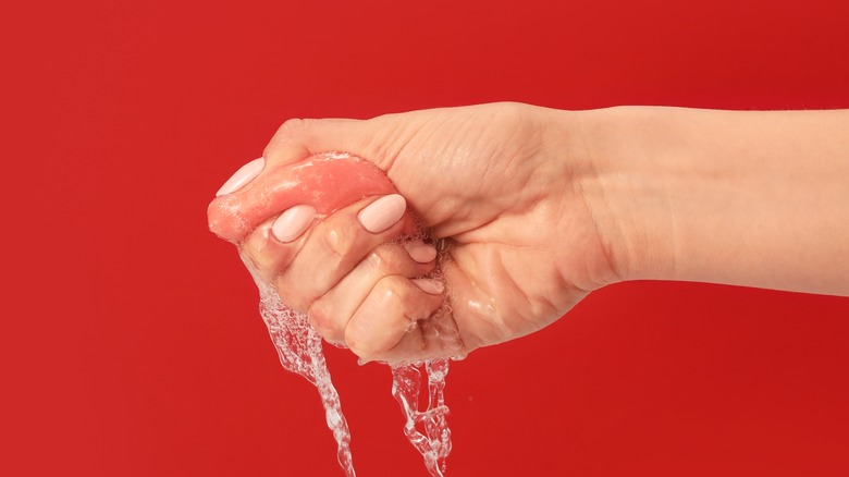 Squeezing water from makeup sponge