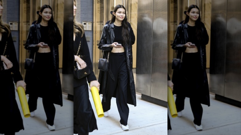 woman wearing all black outfit with white sneakers