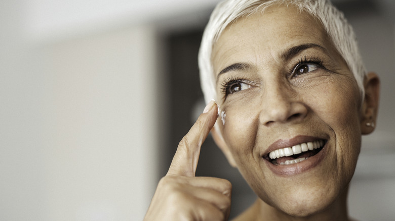 Woman applying face cream