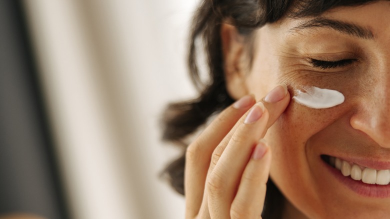woman apply eye cream