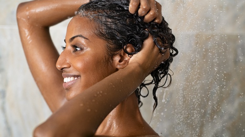 Woman washing her curly hair