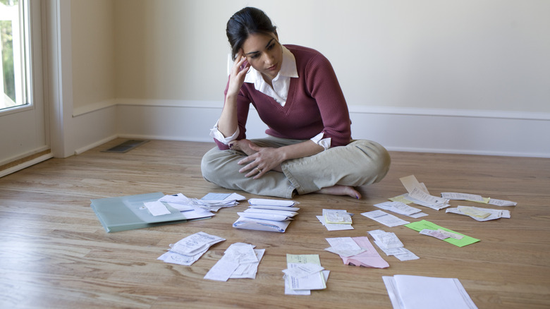 Woman with receipts on floor