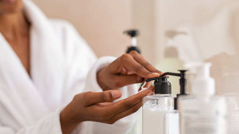 person using hand lotion