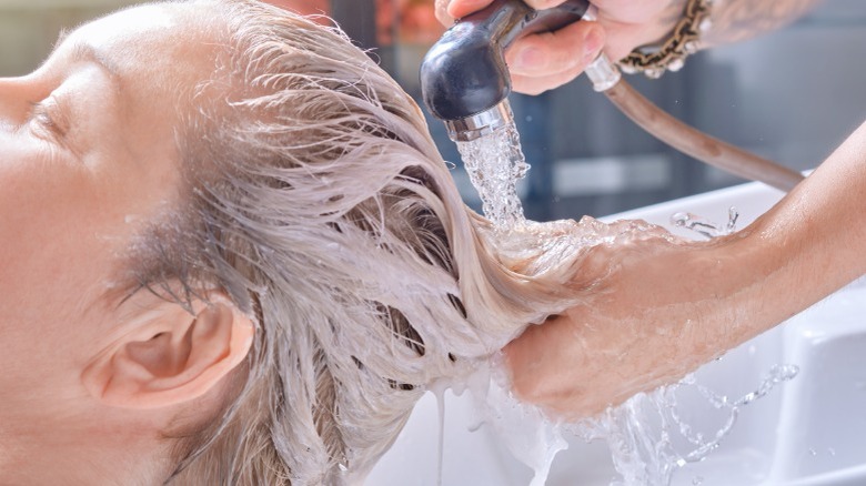 Older woman getting hair washed