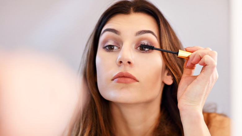 woman applying mascara