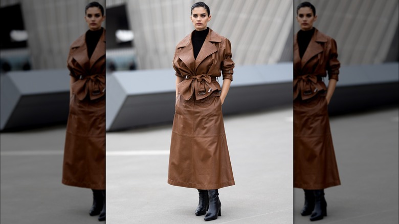 Sara Sampaio in brown leather skirt and jacket