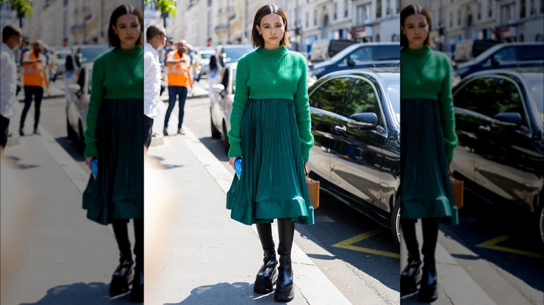 Person in green skirt and sweater