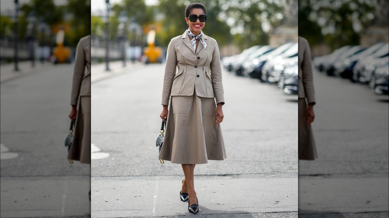 Person in beige skirt suit