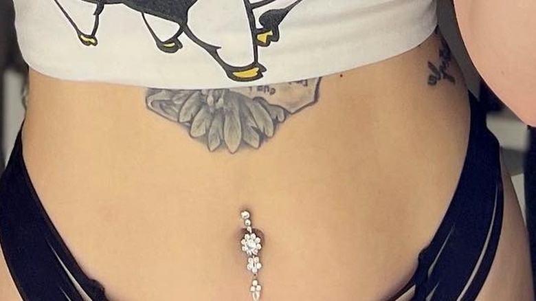 Belly button piercing and tattoo