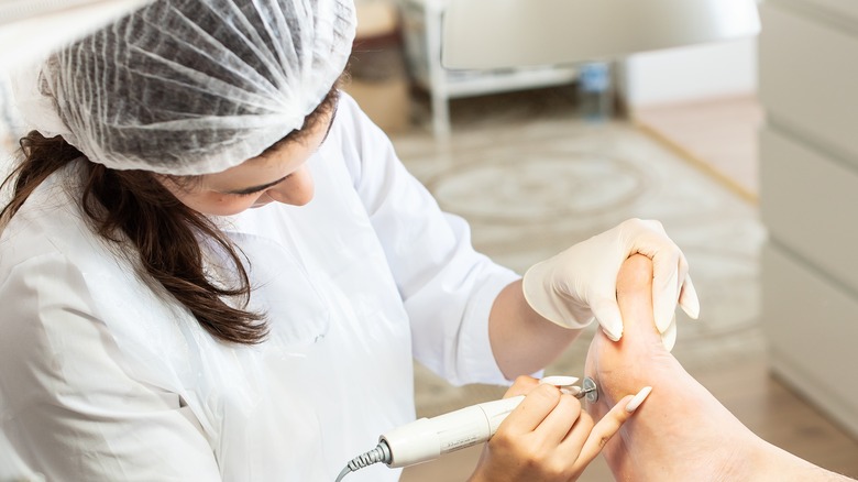 woman examining a foot