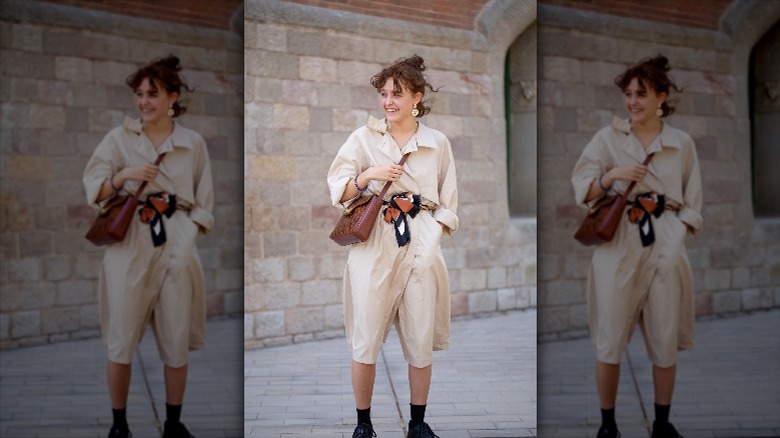 woman wearing jumpsuit with scarf belt