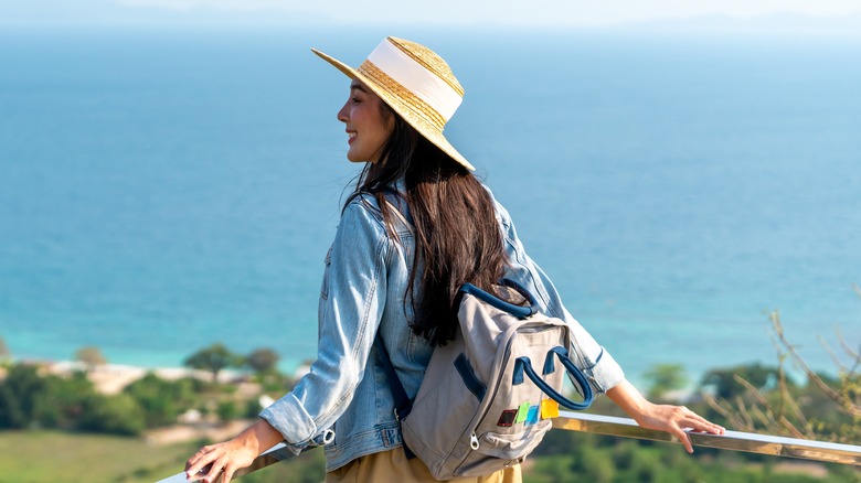 woman wearing backpack and hat