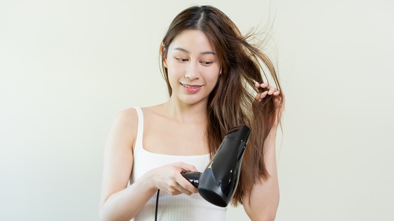 person using a hairdryer