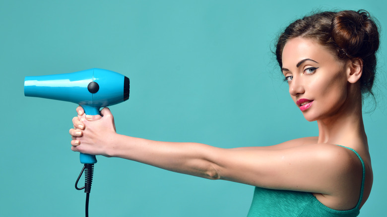 person holding a hairdryer