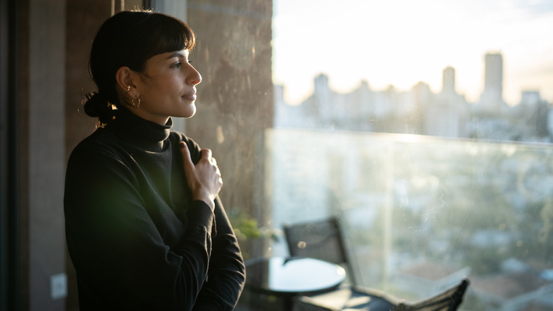 woman looking out window 